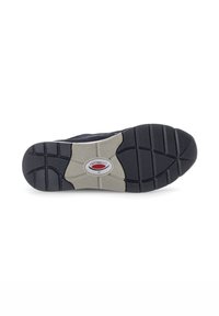 Semelle de chaussure en caoutchouc noir avec un motif texturé et une section grise au centre. Comprend un logo circulaire et une semelle segmentée pour une meilleure adhérence.