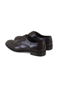 Chaussures habillées en cuir marron avec un detailing perforé, un laçage, un bout rond et un petit talon. Surface lisse avec une finition brillante.