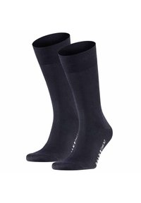 Calcetines azul marino oscuro hechos de una tela suave, con un borde acanalado en la parte superior y un talón reforzado, y con una marca blanca en la zona de los dedos.