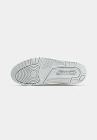 Fehér gumi sneaker talp, textúrált tapadó mintázattal és kerek részletekkel, az oldalon ezüst "JORDAN" felirattal.