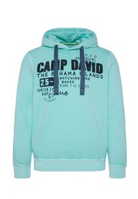 Hoodie verde menta in morbido tessuto, con tasca frontale a marsupio, cordini e stampa di testo in blu navy.
