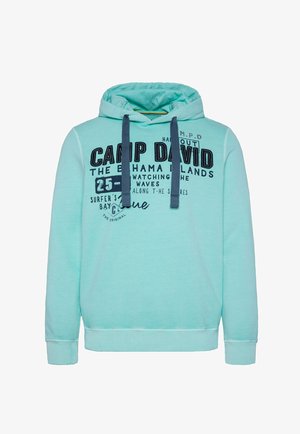 Mintgroene hoodie gemaakt van zachte stof, met een voorste kangoeroezak, trekkoorden en bedrukte tekst in marineblauw.