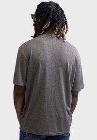 Gray short-sleeve t-shirt with a relaxed fit, made of soft textured fabric. Features a rounded neckline and a straight hem.