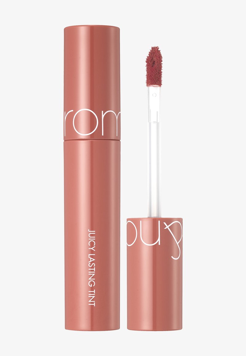 Tinte labial líquido de color rosa en un tubo cilíndrico elegante con acabado brillante. Incluye un aplicador de felpa para una aplicación precisa.