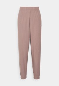 Helle mauve gerippte Jogginghosen mit elastischem Bund und schmalen Bündchen. Mit subtiler Markenkennzeichnung an der Seite. Weiches Baumwollmischgewebe.