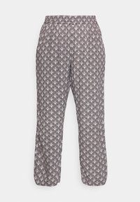 Losse fit broek met elastische tailleband en enkels, met een all-over geometrisch patroon in zwart en wit.