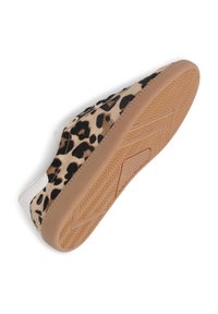Sneaker with leopard print upper, white heel tab, and light brown textured rubber sole angled to show sole pattern.