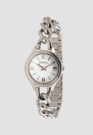 Sølvmetallur med en rund hvid urskive, minimalistiske timemarkører og et kædeforbundet armbånd, der tilføjer ekstra struktur.