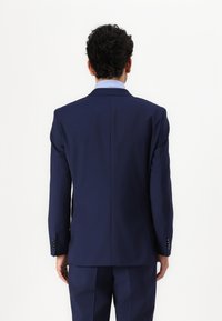 Navy tailored suit jacket with a single vent, structured shoulders, and long sleeves, featuring buttoned cuffs and a smooth texture.