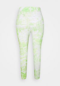 Fehér és világoszöld leggings, hullámos mintával. Rugalmas anyagból készültek, testhezálló fazonúak és közép derékig érnek.