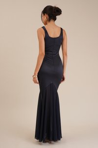 Navy evening gown made of satin and chiffon, featuring a fitted bodice, flared hem, and scoop back with a concealed zipper.