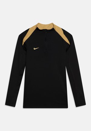 Black long-sleeve sports top with a half-zip collar, featuring gold accents on shoulder seams and a small gold Nike logo on the chest.