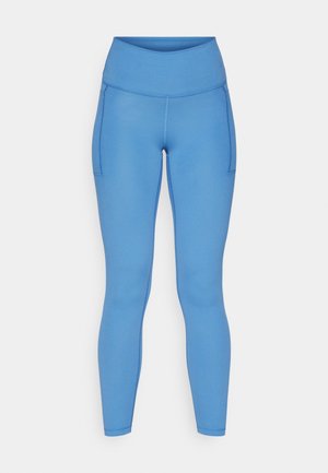 Blue leggings with a high waistband, smooth texture, side pockets, and fitted design for active wear.
