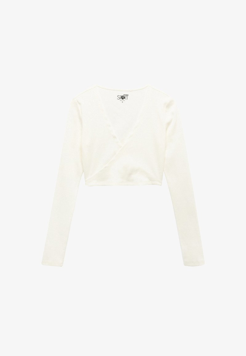 Long-sleeve, cropped wrap top in soft white fabric with a deep V-neck and clean stitching along the edges for a fitted look.