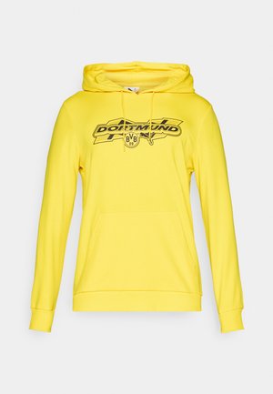 Gelber Hoodie mit einem schwarzen Grafiklogo "DORTMUND" und "BVB 09". Mit Zugbandkapuze und Kängurutasche. Weicher Stoff, gerippte Bündchen und Saum.