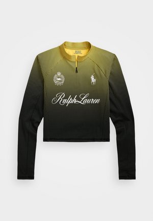 Gecombineerd cropped langarmige mesh top met een verloop van geel naar zwart. Beschikt over witte branding en logo's op de borst en kraag. Ritsluiting.