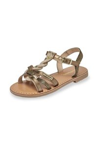 Sandal in bronzo metallico con molteplici cinturini, design intrecciato, fibbia regolabile alla caviglia e suola piatta con finitura testurizzata.