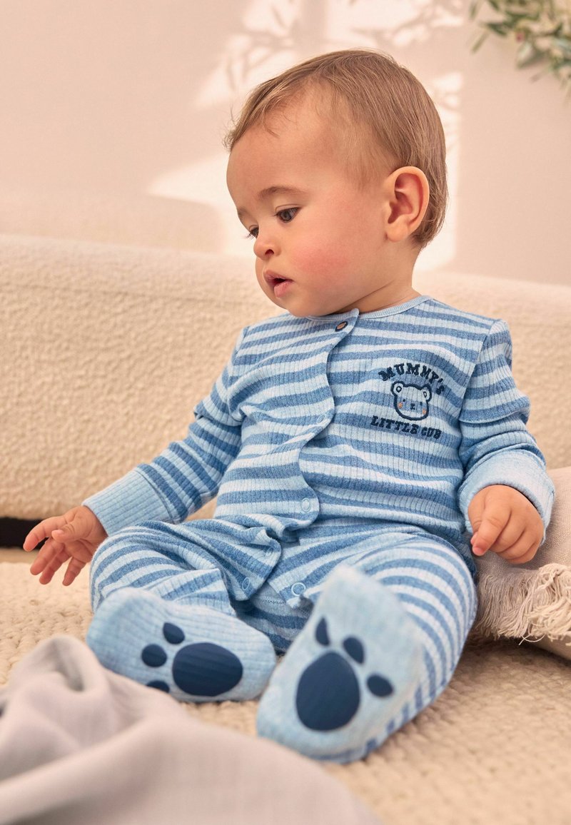 Blue striped baby onesie with snap buttons, ribbed texture, and bear graphic. Non-slip paw prints on feet. Soft fabric with long sleeves.