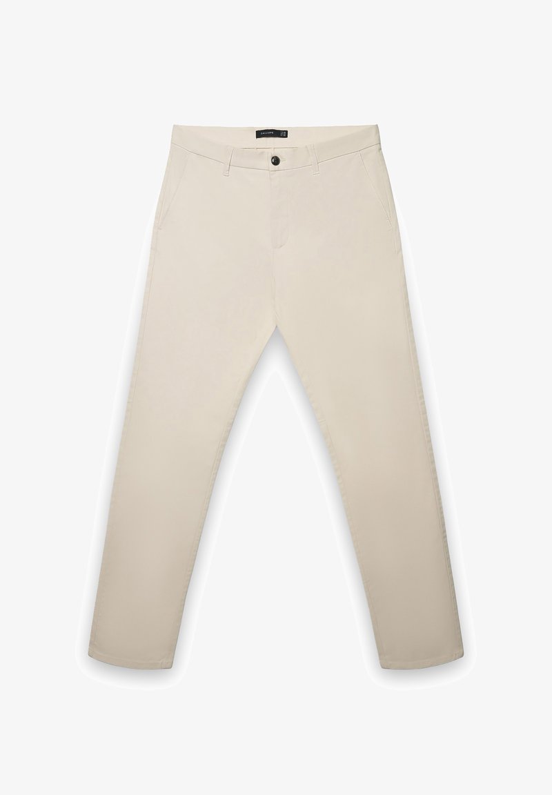 Beige, gerade geschnittene Hose aus Baumwollmischgewebe. Verfügt über zwei Seitentaschen und einen einzelnen Knopfverschluss an der Taille.