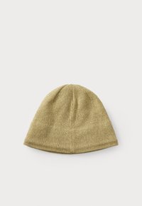 Knit beanie in light gold color with a tapered design. Made from soft fabric, featuring a seamless top and a flexible, textured surface.