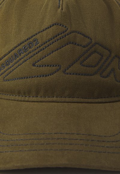 Gorra de béisbol color caqui con logotipo y costuras bordadas en azul oscuro. Presenta una corona estructurada y un visera curva. Textura de tela duradera.