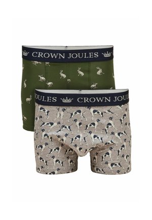 Dos pares de bóxers masculinos con cinturillas "Crown Joules", uno verde con estampados de conejos, otro beige con estampados de perros en blanco y negro.