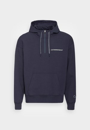 Sweat à capuche bleu marine en tissu doux, avec une poche kangourou, des cordons de serrage et un logo sur la poitrine. Poignets et ourlet côtelés.