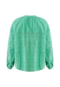 Blusa verde menta con un design texturizzato e ricami ad occhiello, maniche lunghe e schiena plissettata. Materiale in cotone leggero.
