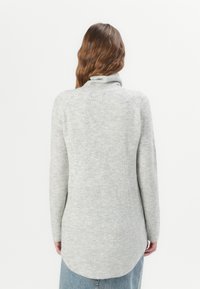 Gray ribbed knit sweater with a tall collar and long sleeves, featuring a rounded hemline and a soft, textured finish.