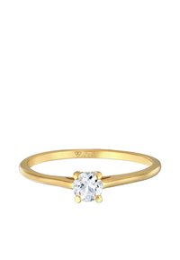 Auksinis žiedas su apvaliu, skaidriu akmeniu, įmontuotu keturių kablių dizainu. Lygi juosta su poliruotu paviršiumi. Žymėjimai apima „375.“