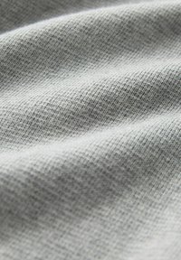 Light gray fabric with a textured surface, featuring a smooth, even weave pattern and subtle variations in shading throughout.