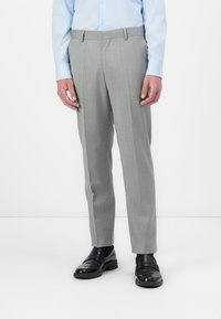 Gray tailored dress pants with a smooth texture, featuring a flat front and side pockets, worn with black shoes and a light blue shirt.