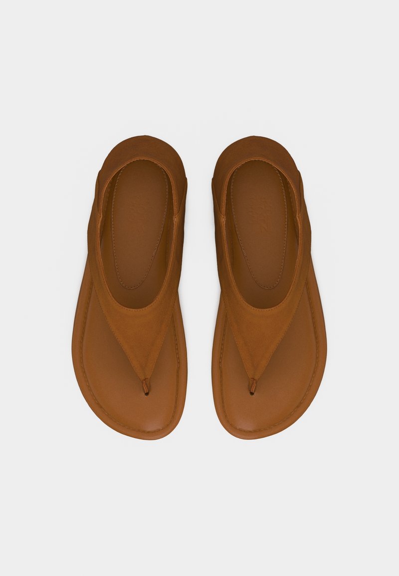 Paire de tongs en cuir marron avec larges sangles et design à bout rond, présentées à plat sur un fond clair.