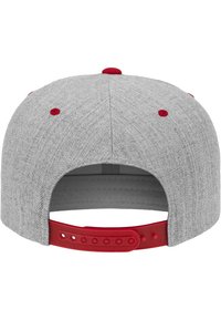 Cappellino da baseball grigio con tessuto testurizzato, dettagli rossi nella chiusura posteriore e sul bottone, chiusura regolabile a scatto e visiera curva.