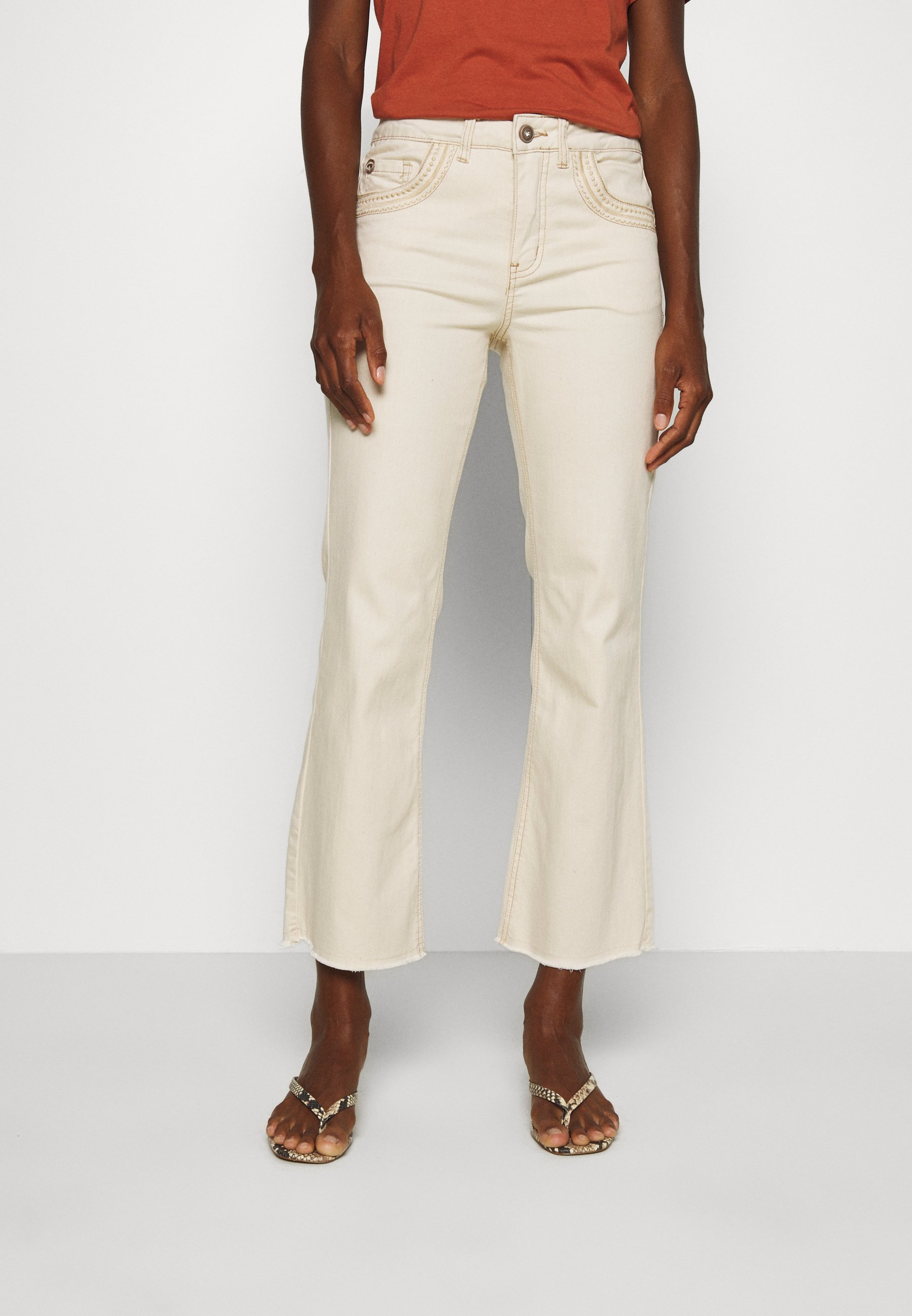 cream slim fit jeans