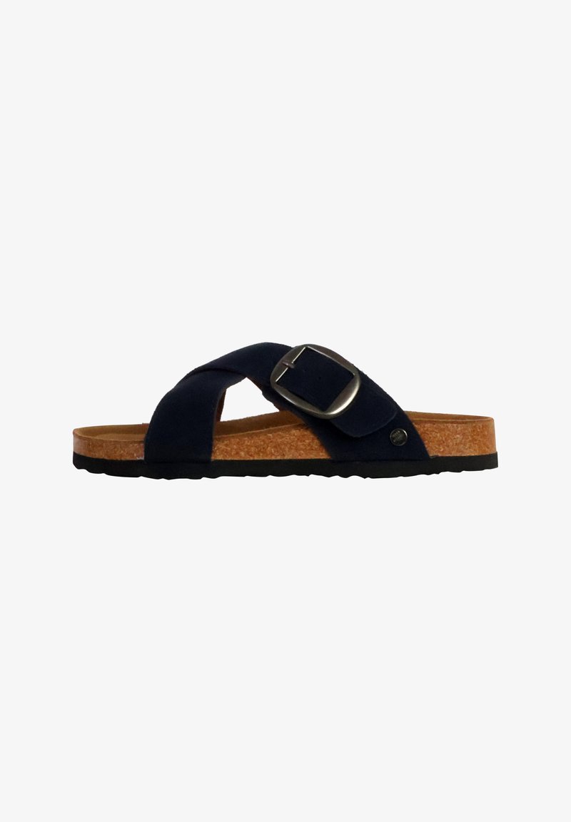 Sandale noire unique avec larges brides croisées, grande boucle argentée, semelle intérieure en liège et semelle extérieure en caoutchouc noir, vue de profil latéral.