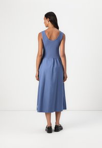 Blue sleeveless dress with a fitted bodice and flared skirt, made from soft fabric, featuring a scoop back and knee-length hem.