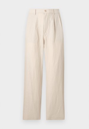 Beige linen trousers with a loose fit, featuring a flat front, single button closure, and two pockets. Wrinkled texture adds detail.