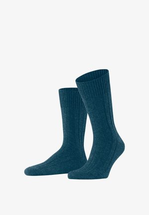 Geribbelde gebreide sokken in donker teal, met een hoge manchet en een zachte, gestructureerde stof voor comfort. Geschikt voor casual of formele kleding.