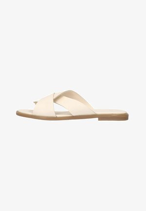 Beige leren slippers met een kruisband ontwerp, platte zool en minimalistisch profiel. Soepele textuur en lichte kleur voor veelzijdigheid.