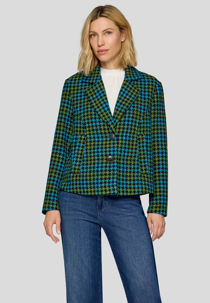 Green and blue checkered blazer with a notched collar, two front buttons, and a textured fabric, paired with dark denim jeans.