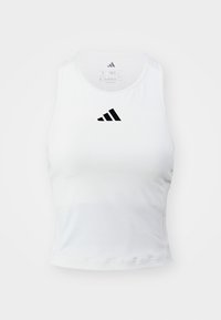 Top court de sport blanc sans manches avec logo Adidas noir centré sur la poitrine, doté d'une coupe ajustée et d'un col rond.