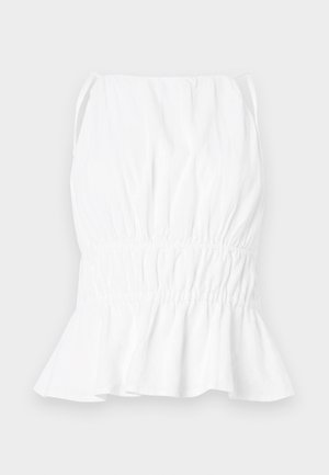 Balta bezpiedurkņu blūze ar savilktu vidukli un izplešanos apakšā. Izgatavota no viegla auduma, ar mīkstu tekstūru un regulējamām siksnām.