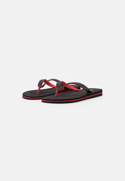 Black and red flip-flops with rubber straps and a textured footbed, featuring a slim design and a thin red accent on the sole.