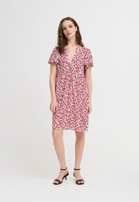 Floral dress with pink and green pattern, short flutter sleeves, deep V-neck, button details, knee-length, made from lightweight fabric.