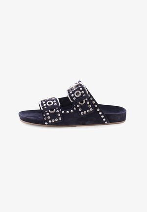 Black slide sandal with two wide straps, large silver buckles, and silver stud detailing on a flat sole.