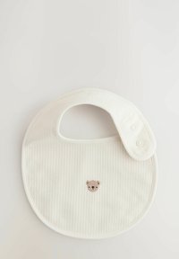 Cream-colored bib with subtle vertical stripes, featuring a small bear face embroidery at the center and a snap closure on the side.