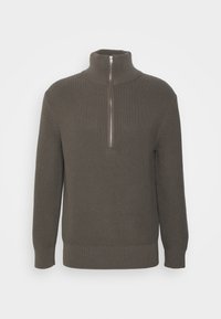 Khaki pullover neule, jossa on korkea kaulus ja neljäsosavetoketju. Teksturoitu ribbineule, pitkät hihat ja tiukka helmareuna. Yksinkertainen muotoilu ilman kuvioita.