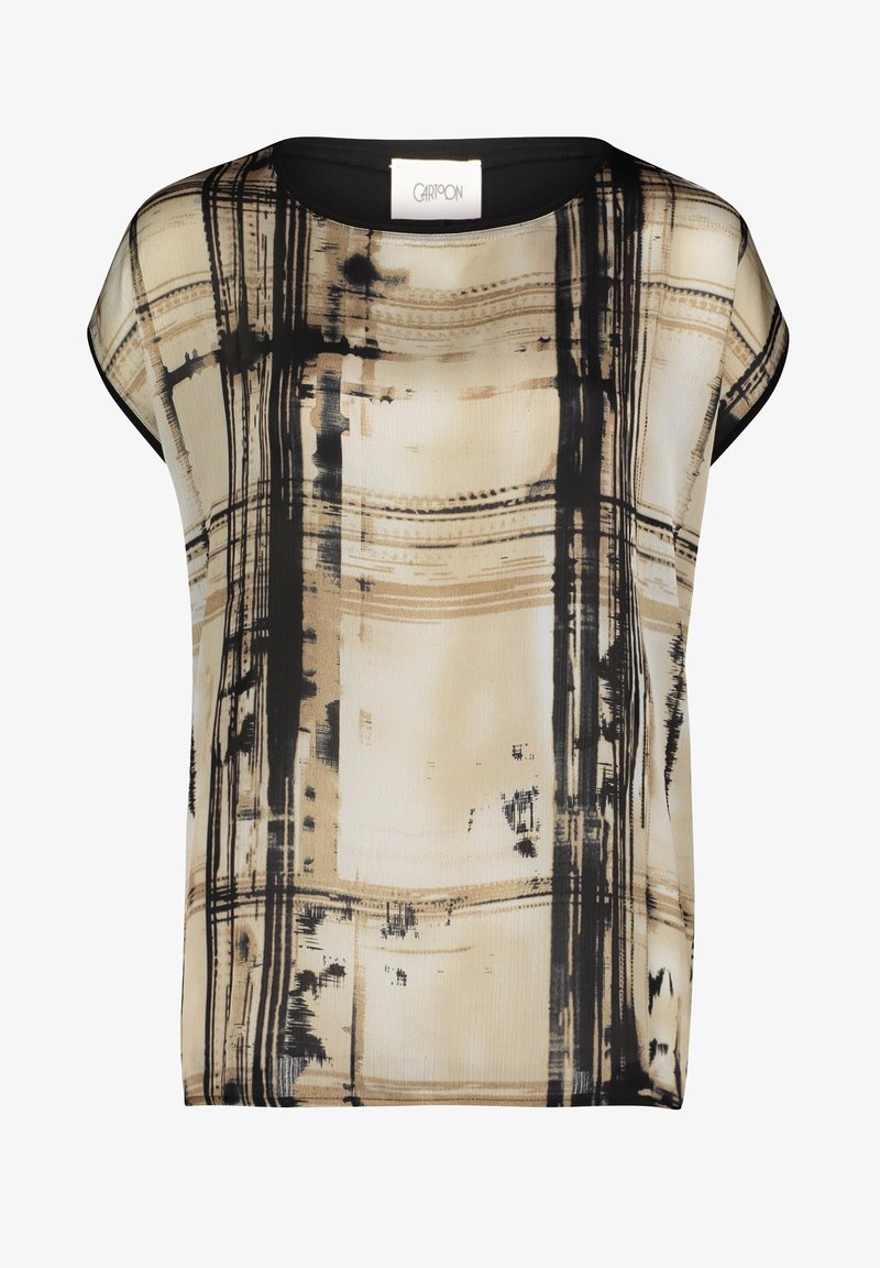 T-shirt à manches courtes, ample, de couleur beige avec un motif abstrait noir. Fabriqué en tissu léger avec une texture lisse et un col arrondi.