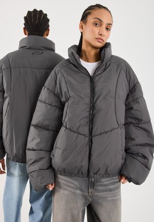 Gray puffer jacket with a high collar, zip closure, and oversized fit. Textured, quilted design with gathered hem and minimal branding.